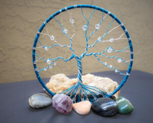 blue and white swirls give this tree the look of refreshing peppermint. It is adorned with glass crystal beads